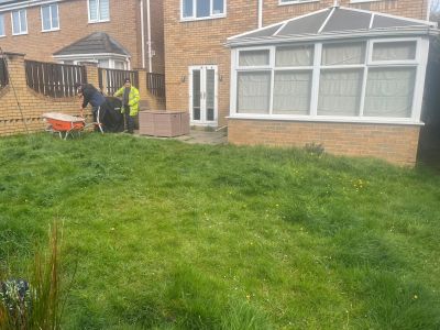 grass lawn in front of a house with white windows